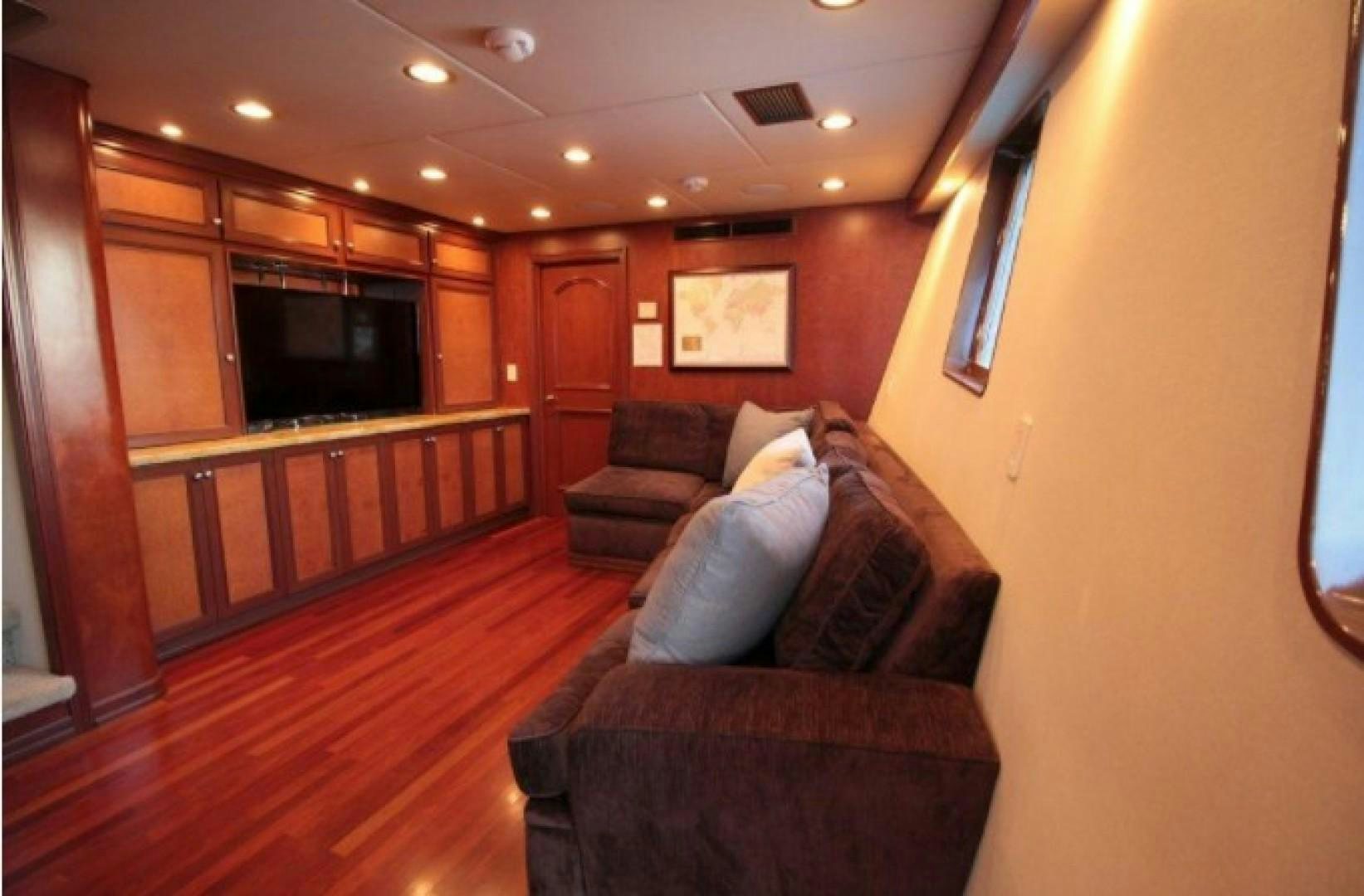 a living room with a couch and a television aboard HURACAN Yacht for Sale
