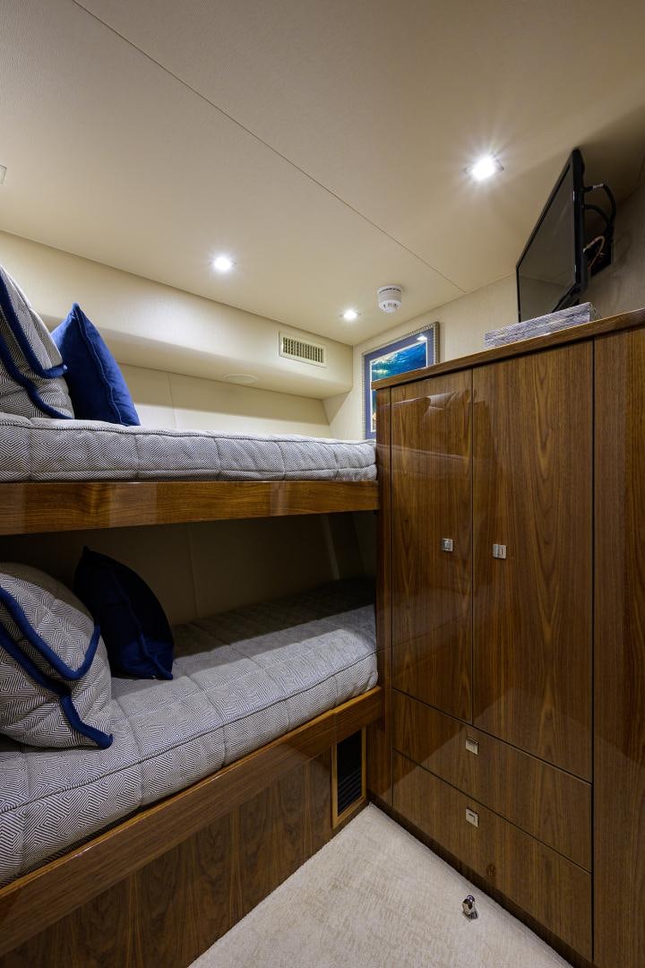 a room with a bed and a dresser aboard Renegade Yacht for Sale