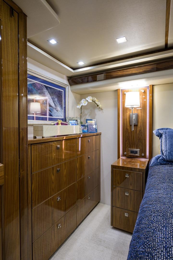 a bedroom with a dresser and a mirror aboard Renegade Yacht for Sale
