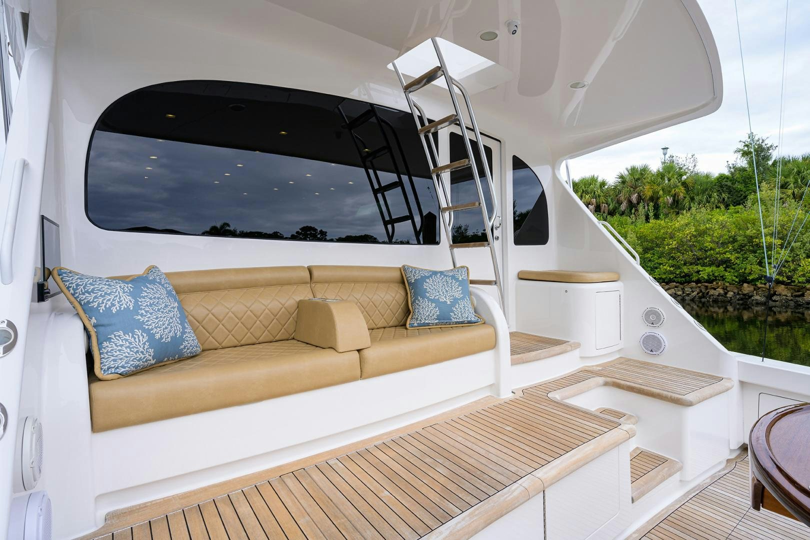 a white tent with a couch and a table and a window aboard Renegade Yacht for Sale