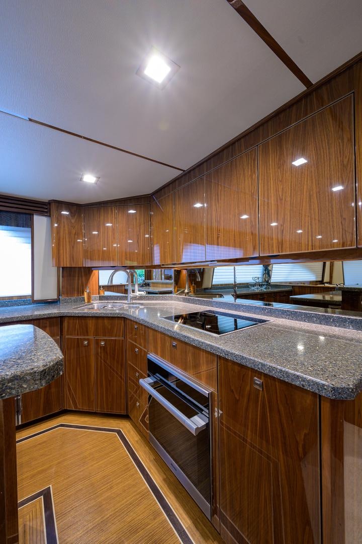 a kitchen with wooden cabinets aboard Renegade Yacht for Sale