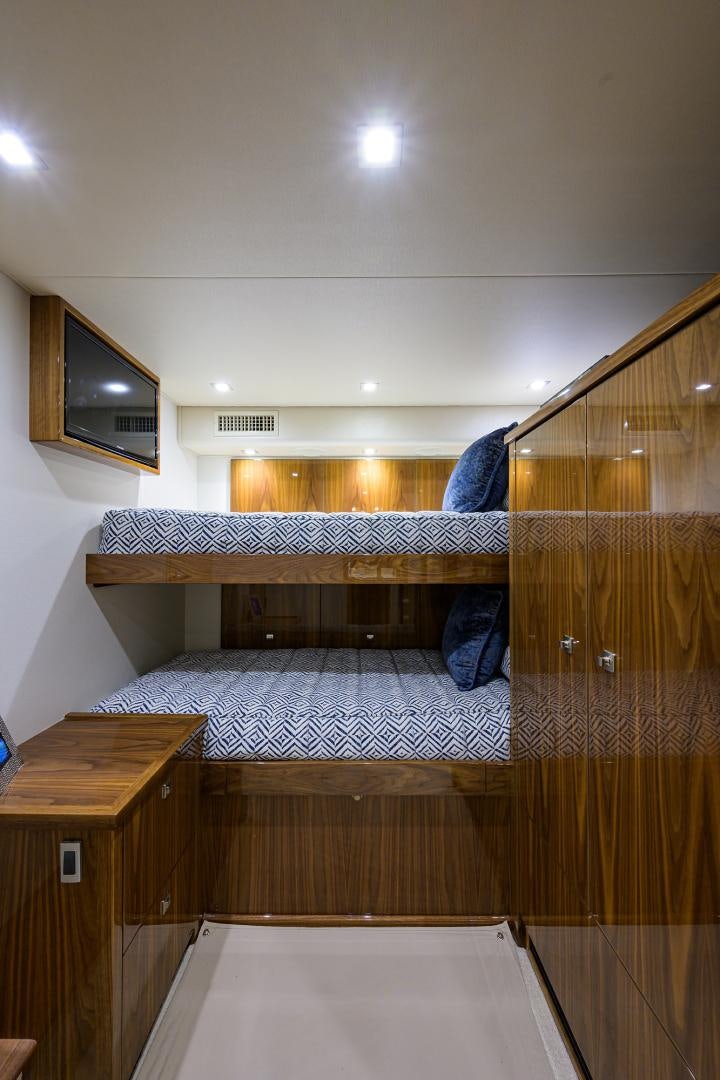 a bed with a mirror above it aboard Renegade Yacht for Sale