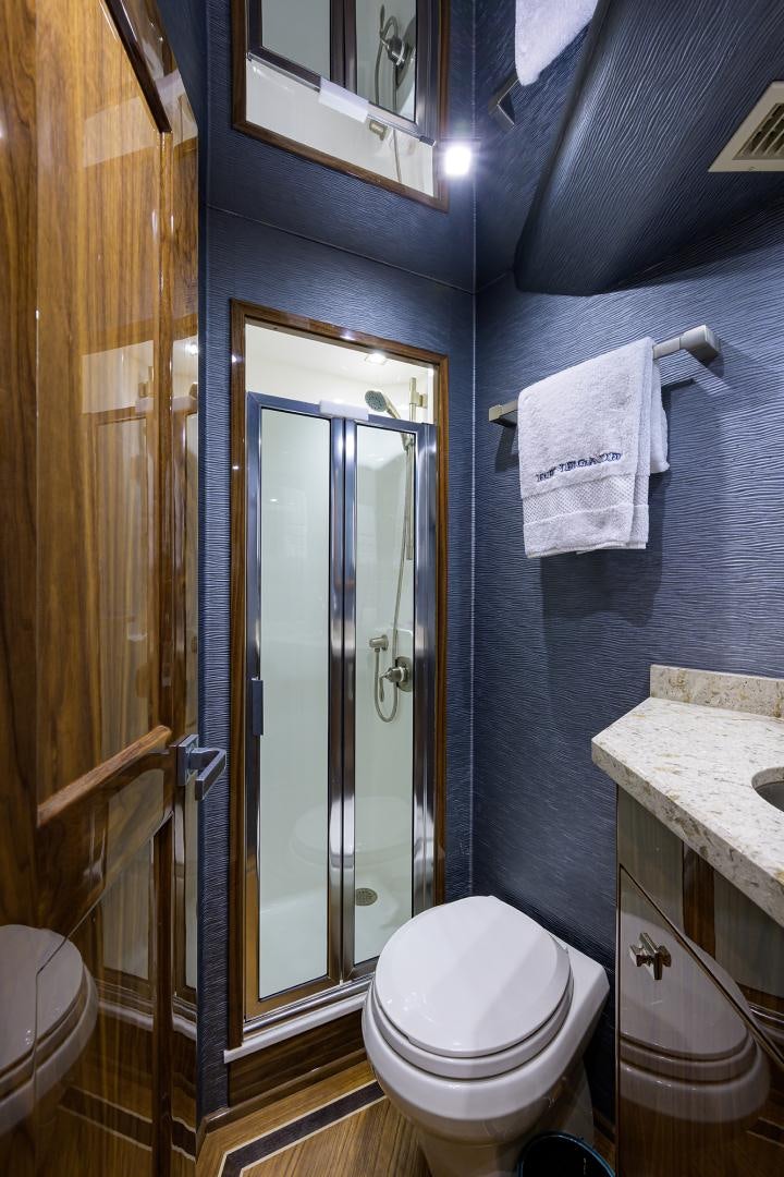 a bathroom with a glass shower door aboard Renegade Yacht for Sale