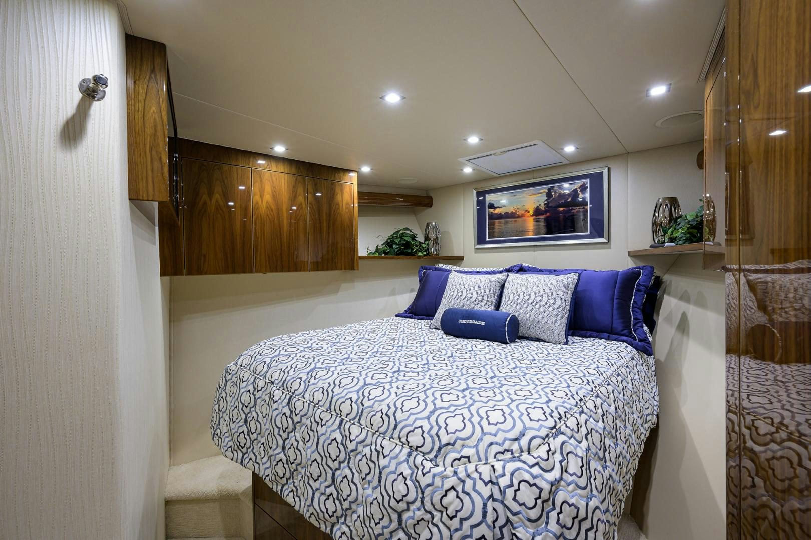 a bed with blue and white sheets aboard Renegade Yacht for Sale