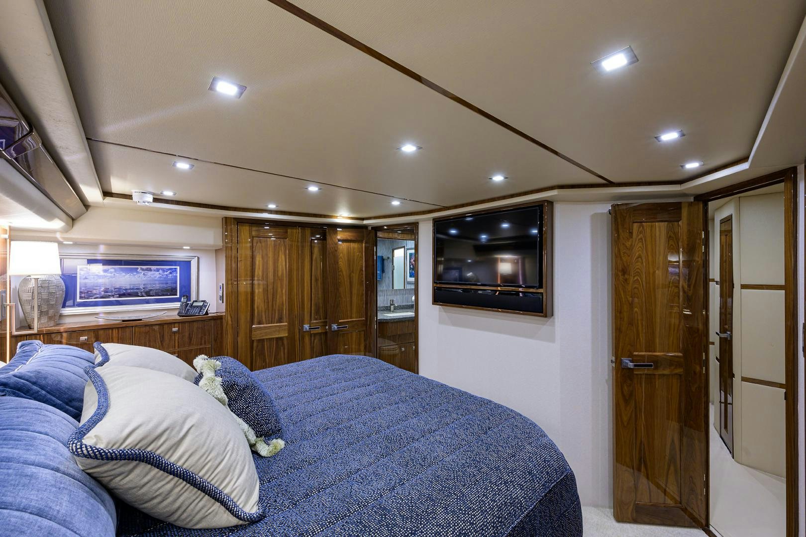 a bedroom with a bed and a television aboard Renegade Yacht for Sale
