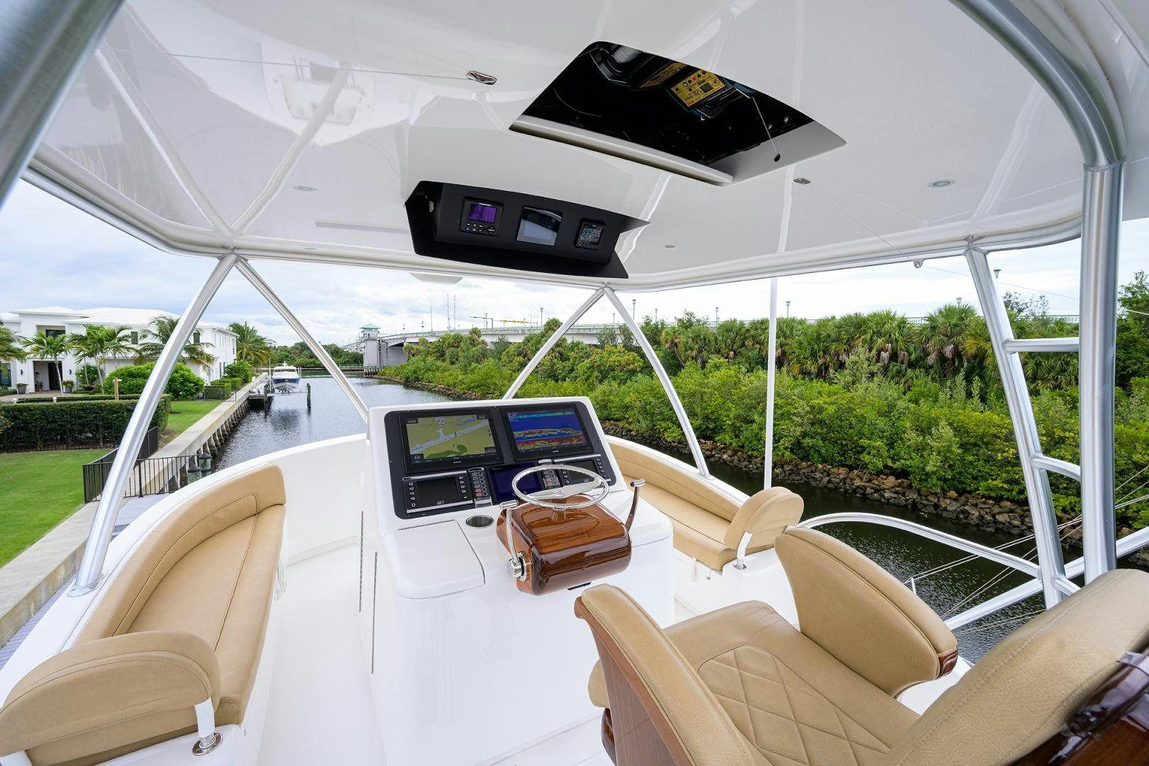 inside of a white tent with a table and chairs and a black screen aboard Renegade Yacht for Sale