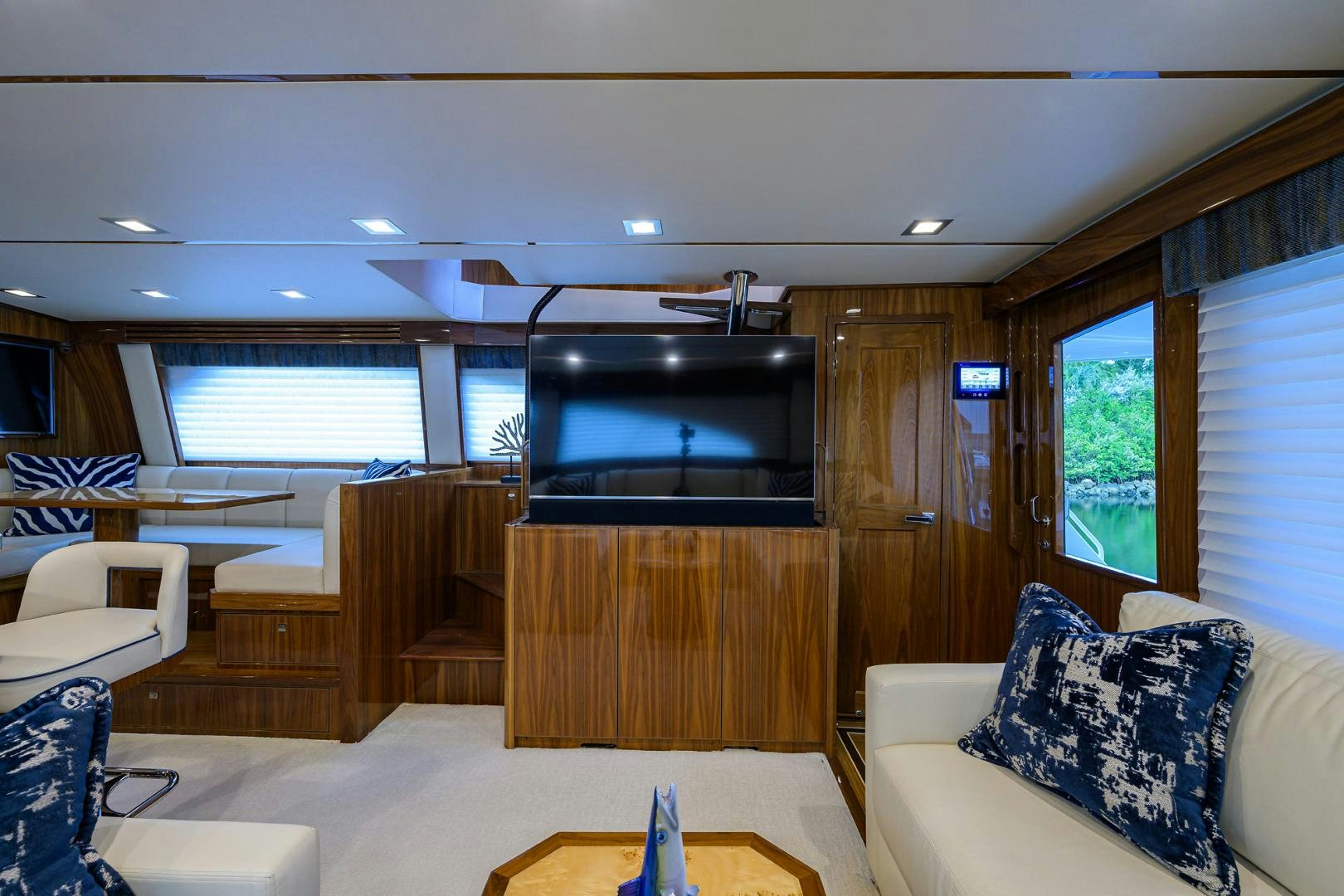 a room with a tv and a couch aboard Renegade Yacht for Sale