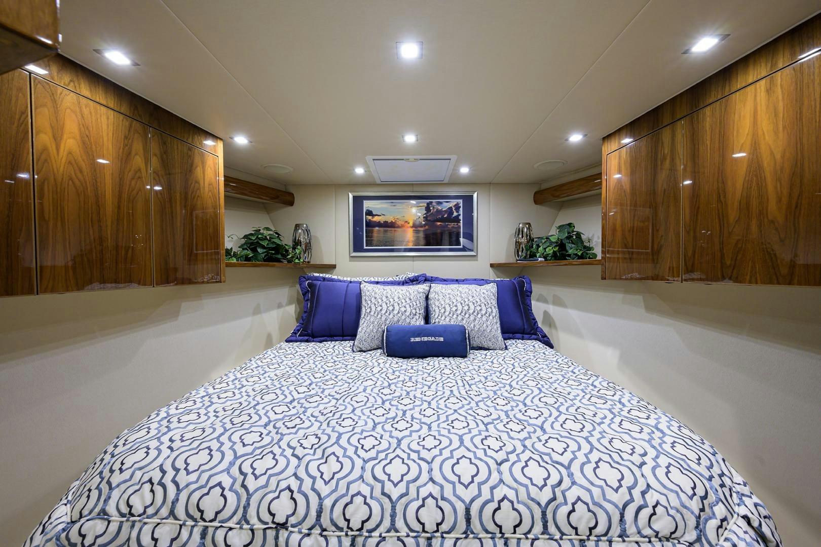 a large room with a bed and a tv on the wall aboard Renegade Yacht for Sale