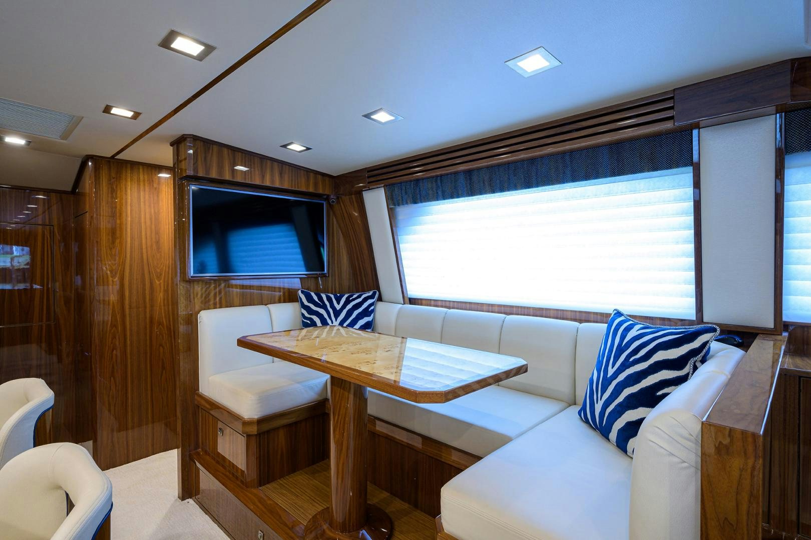a room with a table and chairs aboard Renegade Yacht for Sale