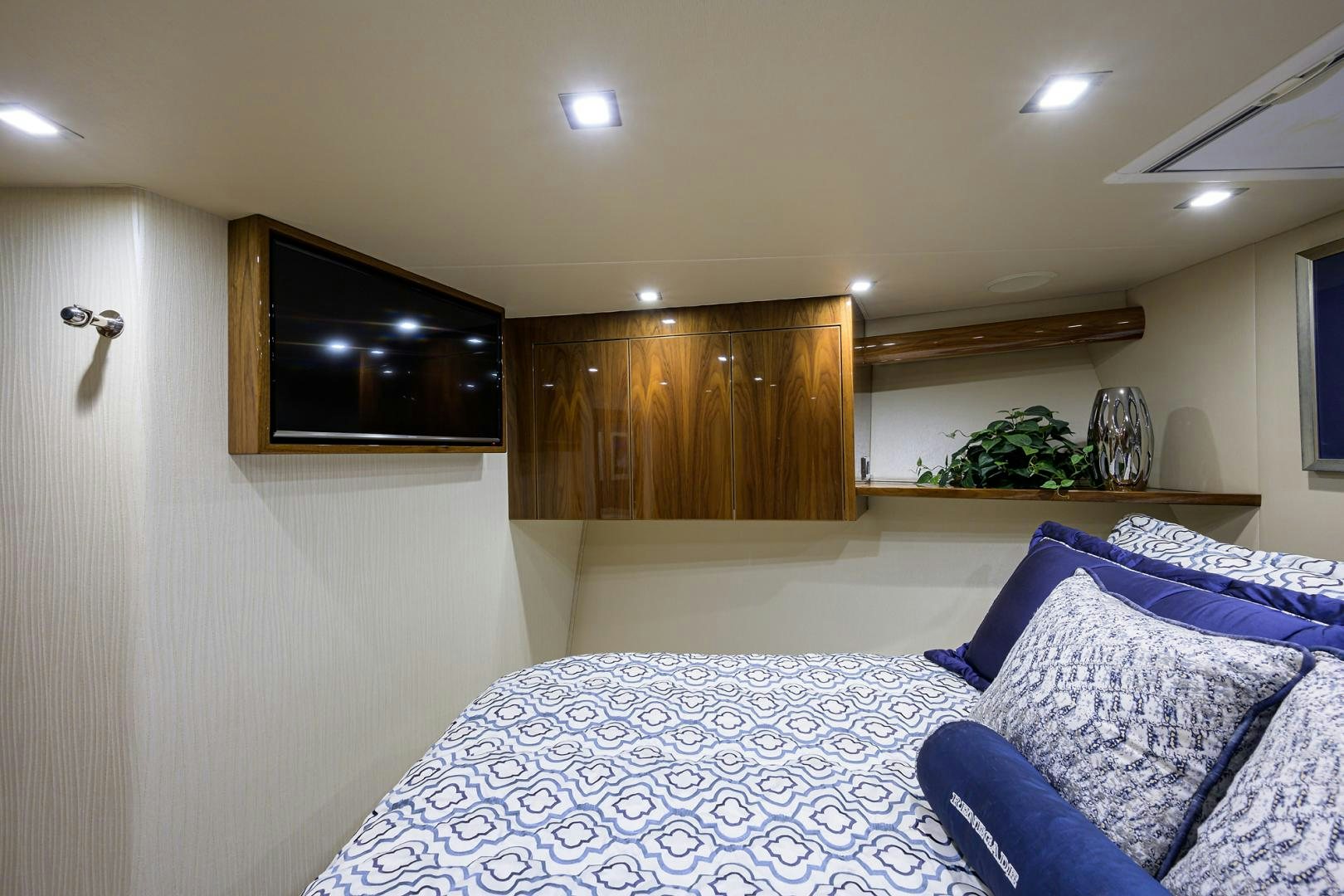 a bedroom with a tv and a dresser aboard Renegade Yacht for Sale
