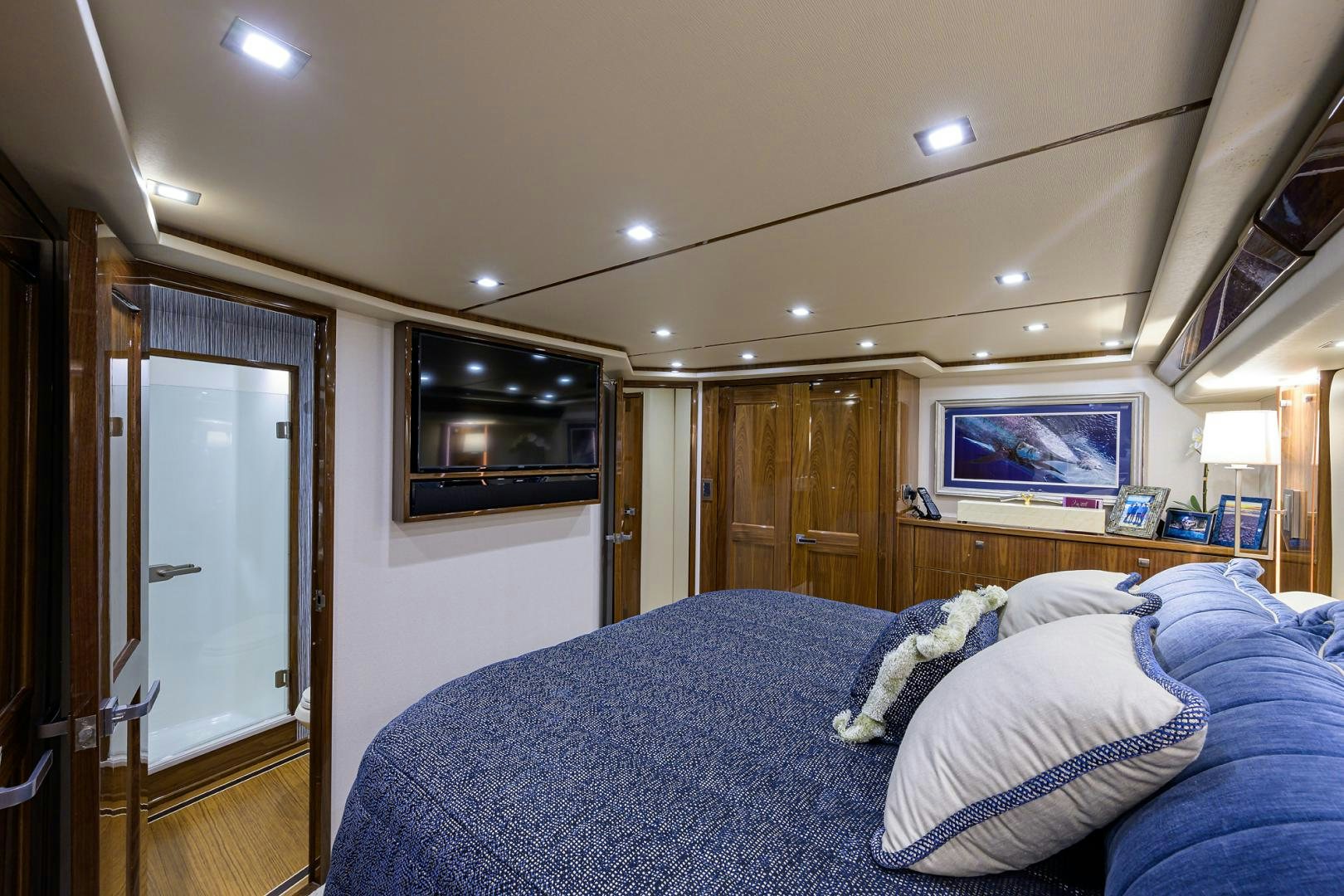 a bedroom with a bed and a television aboard Renegade Yacht for Sale
