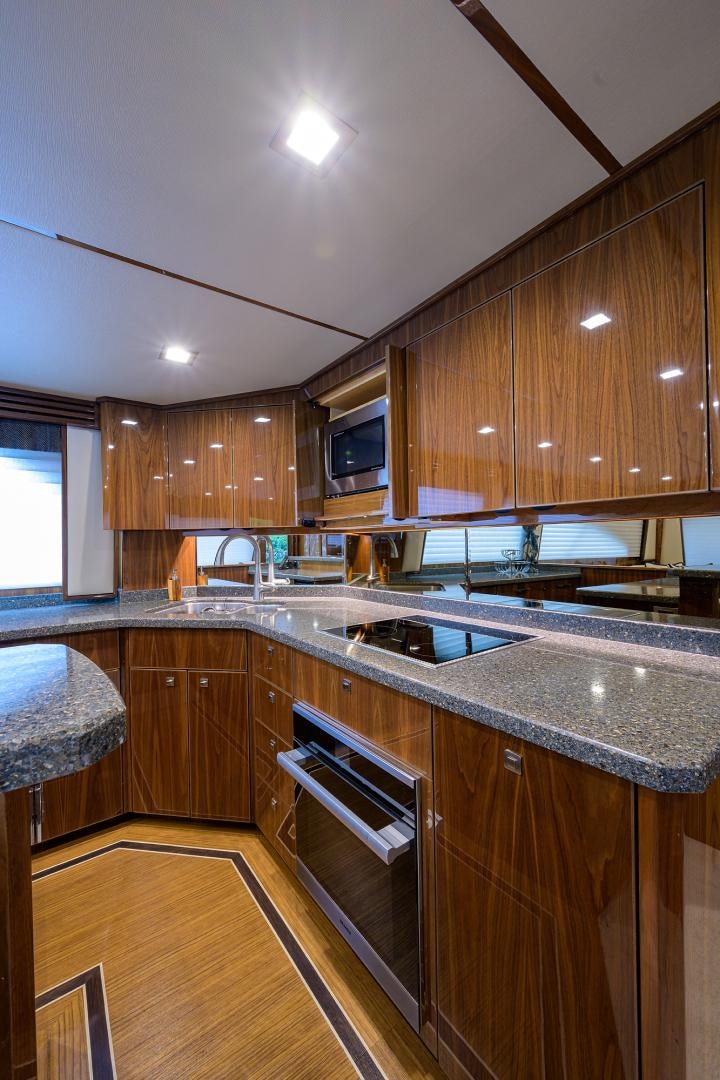 a kitchen with wooden cabinets aboard Renegade Yacht for Sale