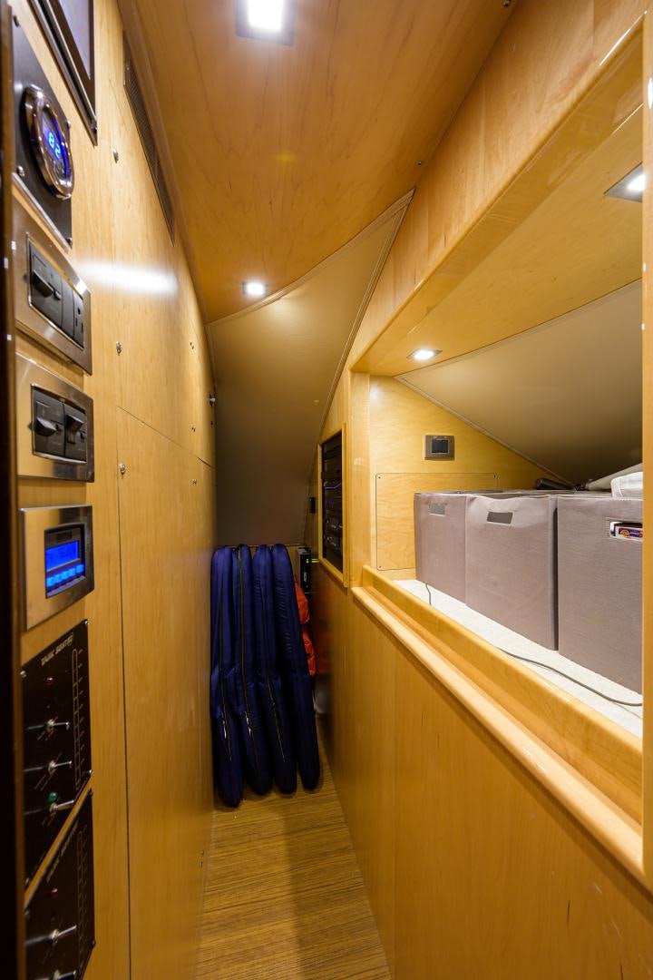 a hallway with a closet and clothes on the wall aboard Renegade Yacht for Sale