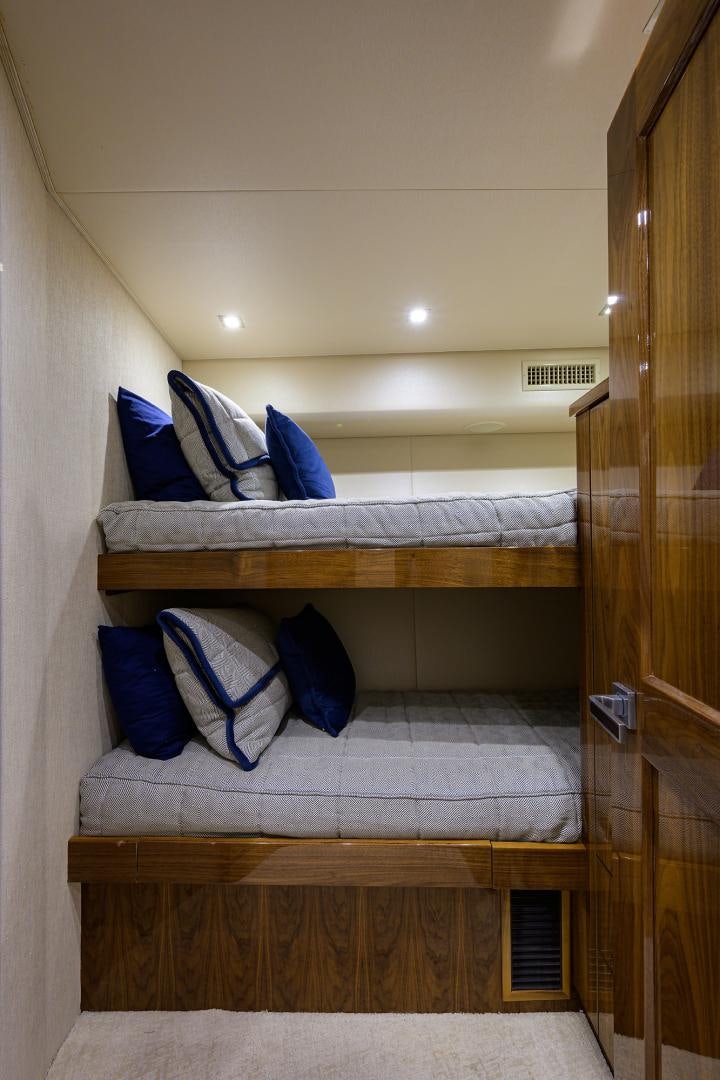 a bed with a blue pillow aboard Renegade Yacht for Sale