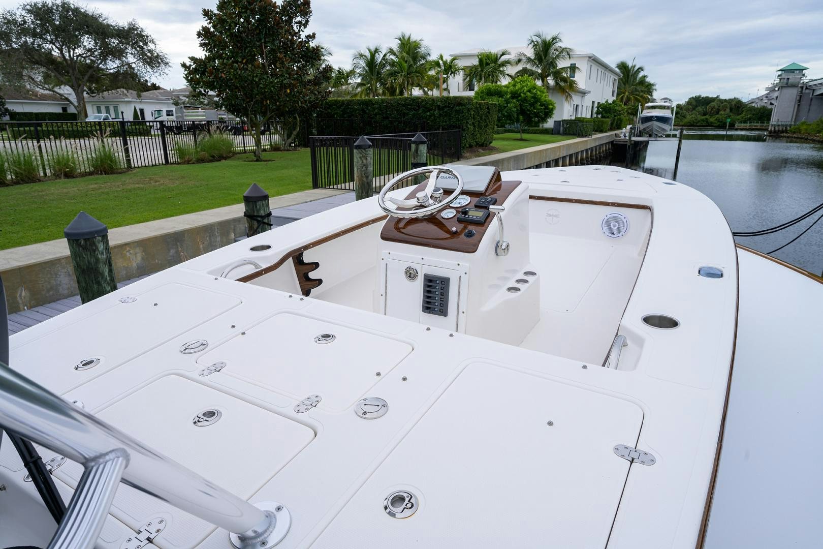 a white boat with a black and white stripe on the front aboard Renegade Yacht for Sale