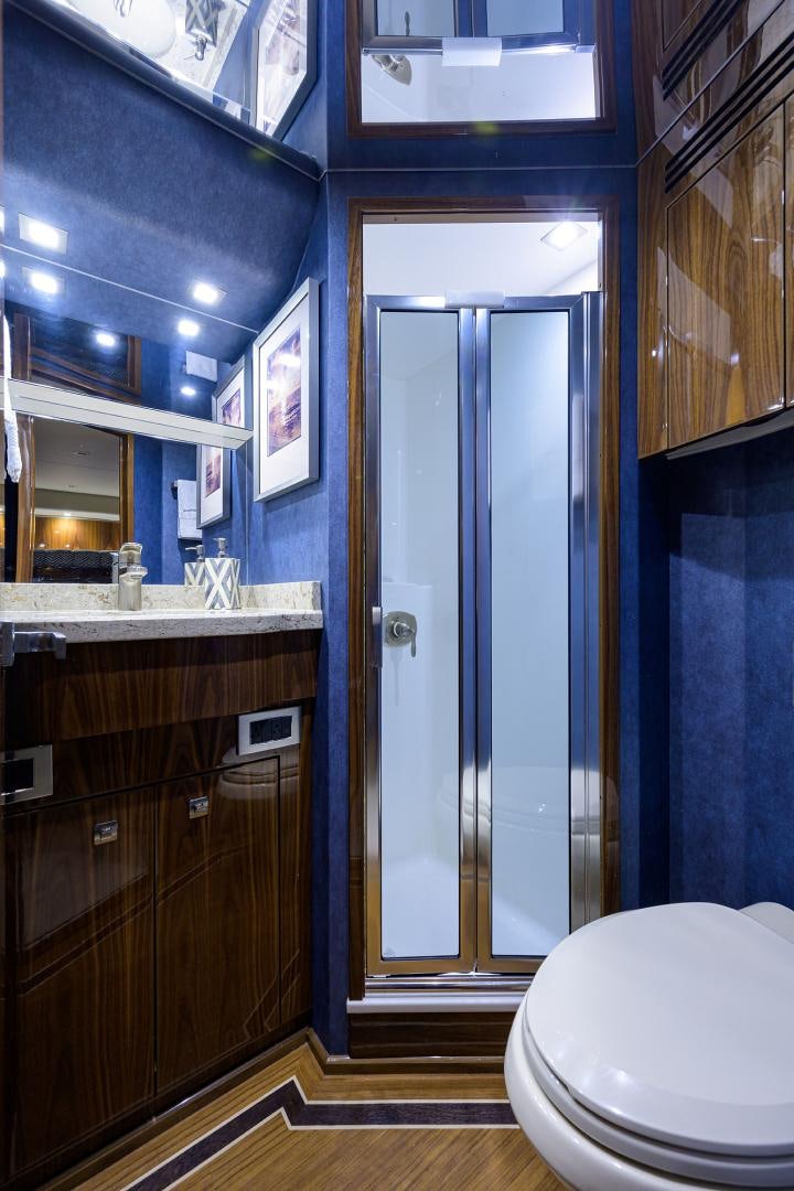 a bathroom with a glass shower aboard Renegade Yacht for Sale