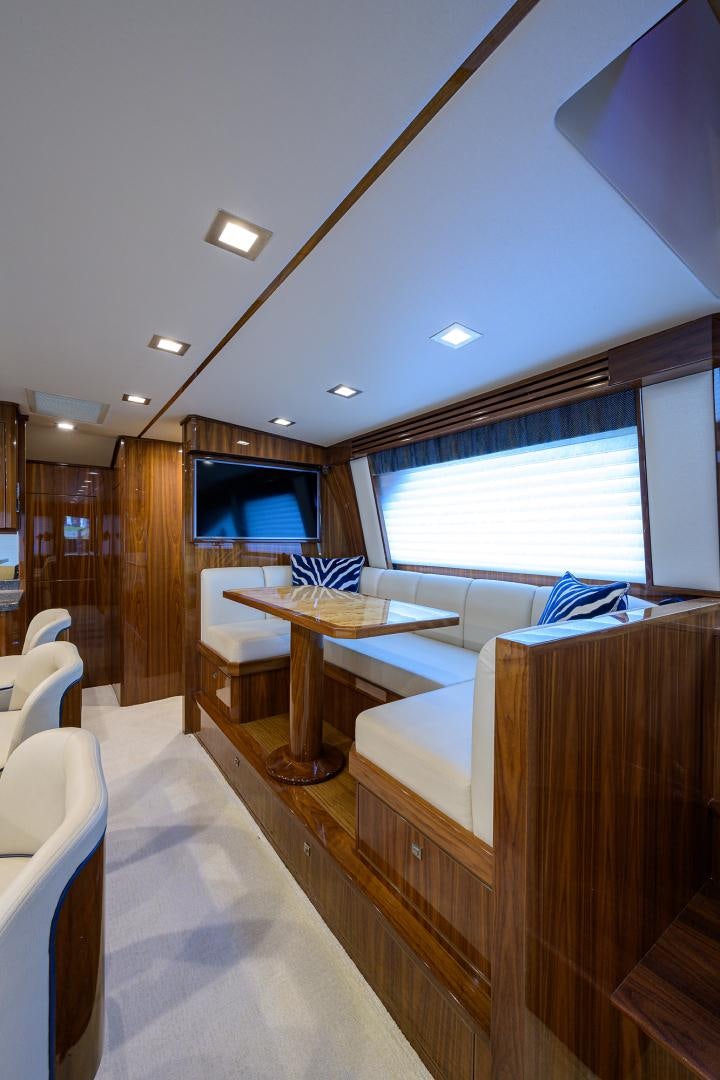 a room with a table and chairs aboard Renegade Yacht for Sale