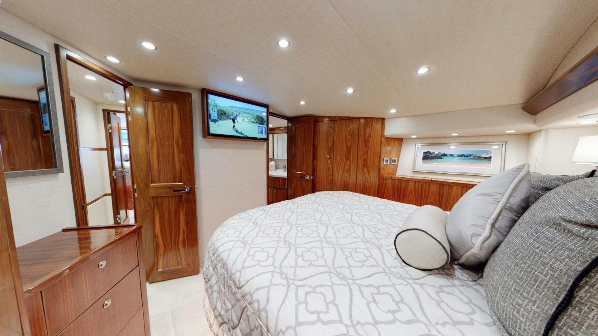 a bedroom with a bed and a television aboard WONDER Yacht for Sale