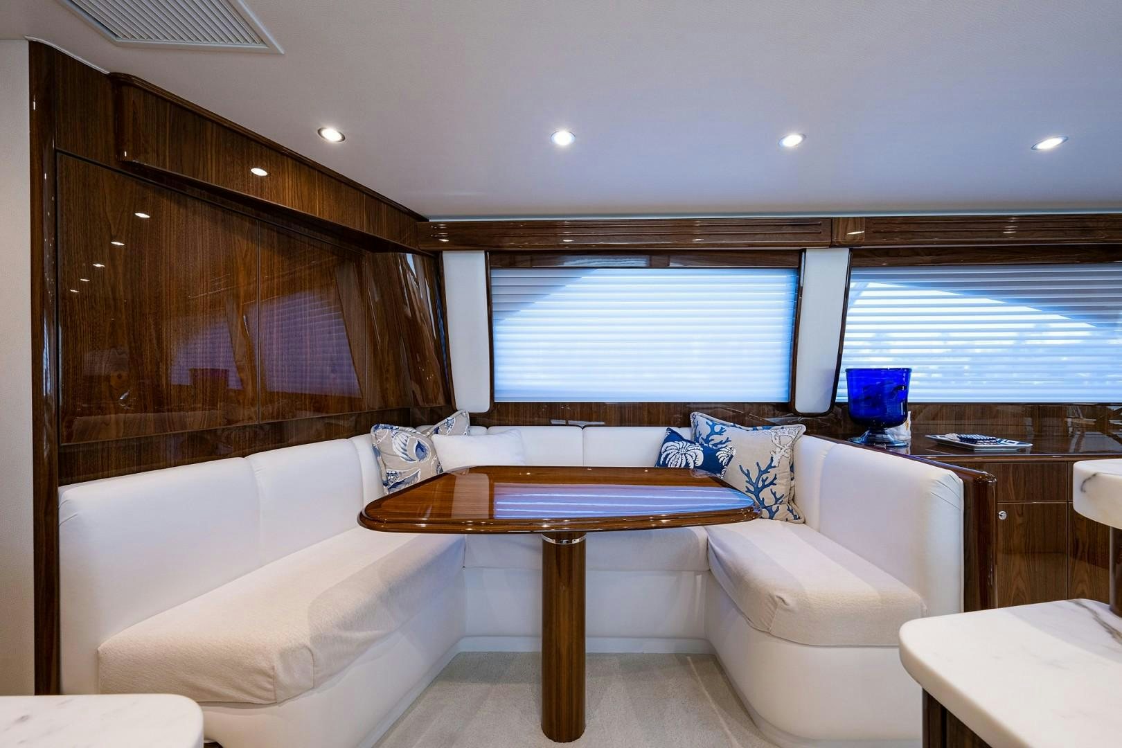 a room with a table and chairs aboard REEL CRAZY Yacht for Sale