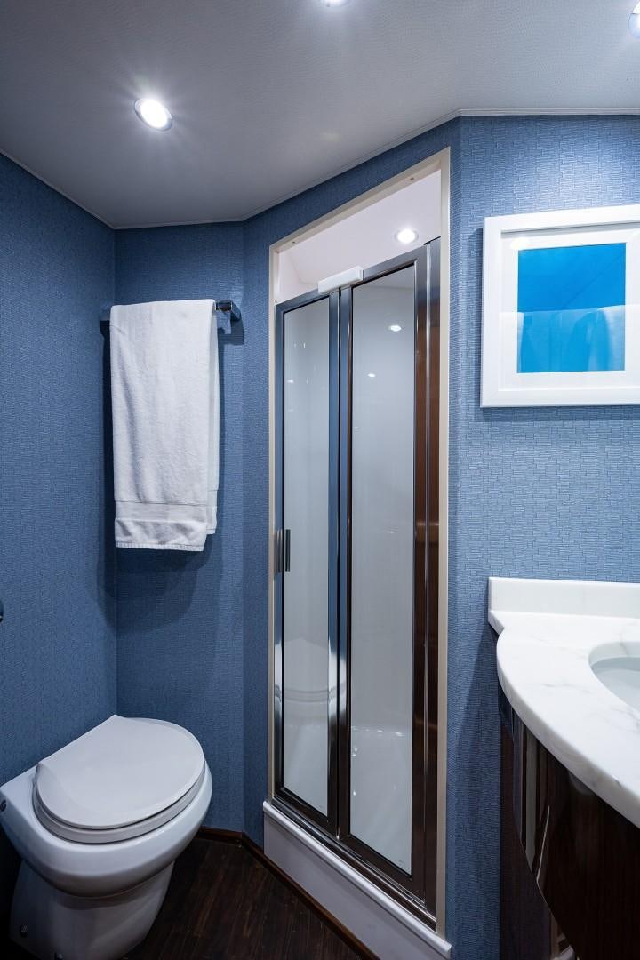 a bathroom with a glass shower aboard REEL CRAZY Yacht for Sale