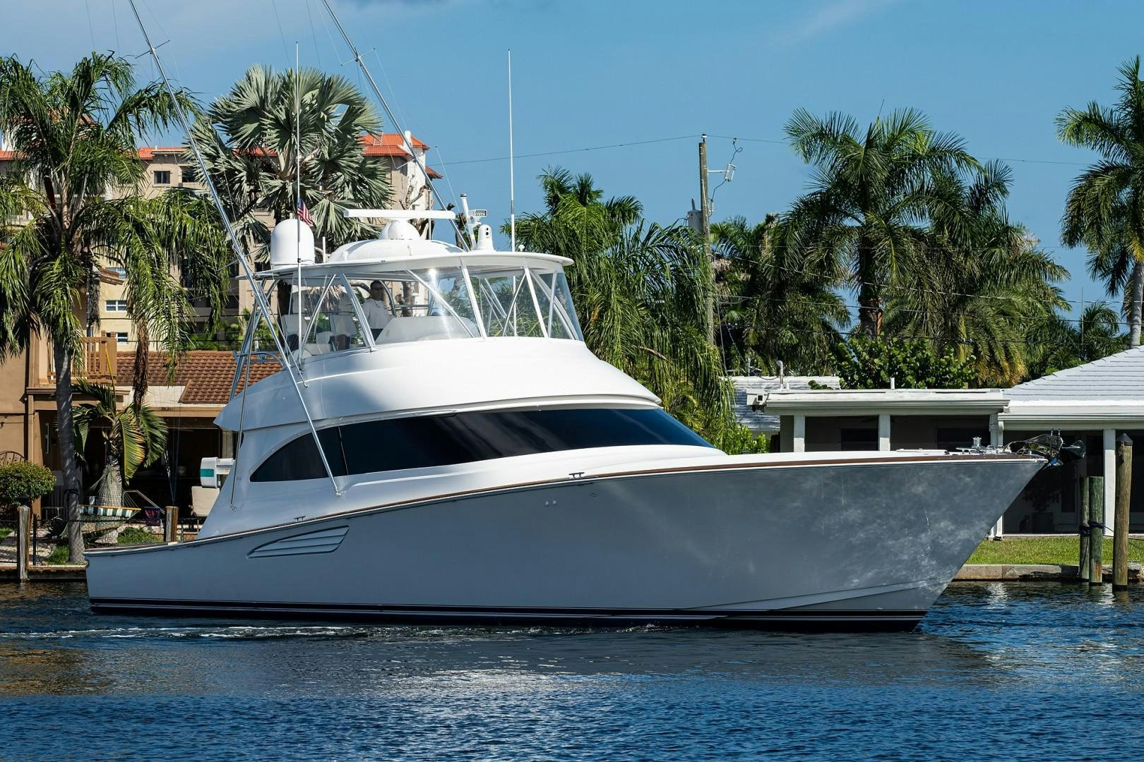 a white boat in a harbor aboard REEL CRAZY Yacht for Sale