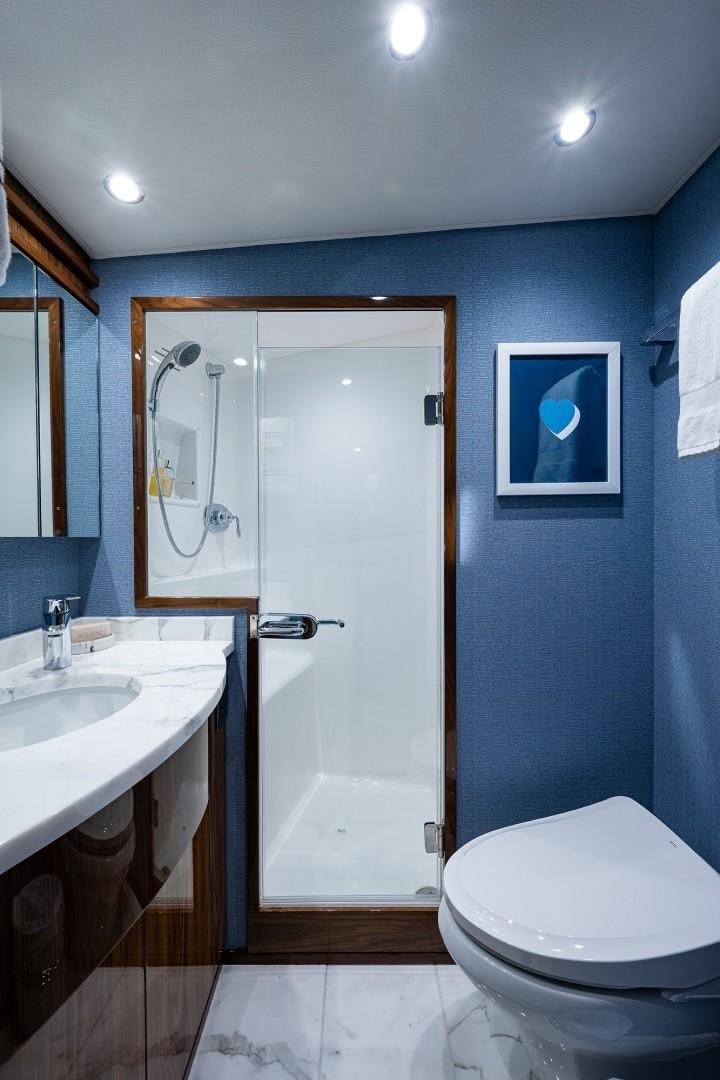 a bathroom with a toilet and a sink aboard REEL CRAZY Yacht for Sale