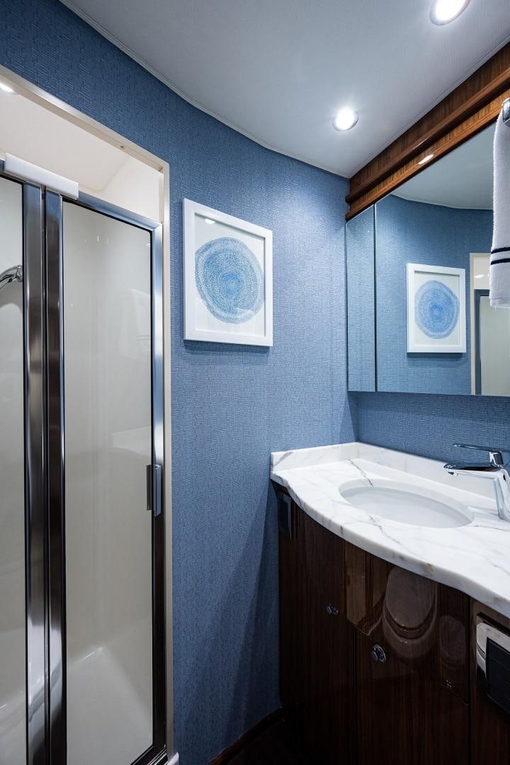 a bathroom with a sink and a mirror aboard REEL CRAZY Yacht for Sale