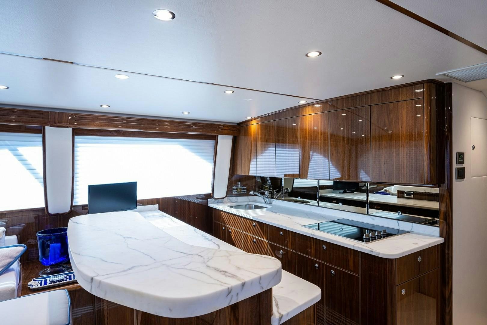 a kitchen with a large white table aboard REEL CRAZY Yacht for Sale