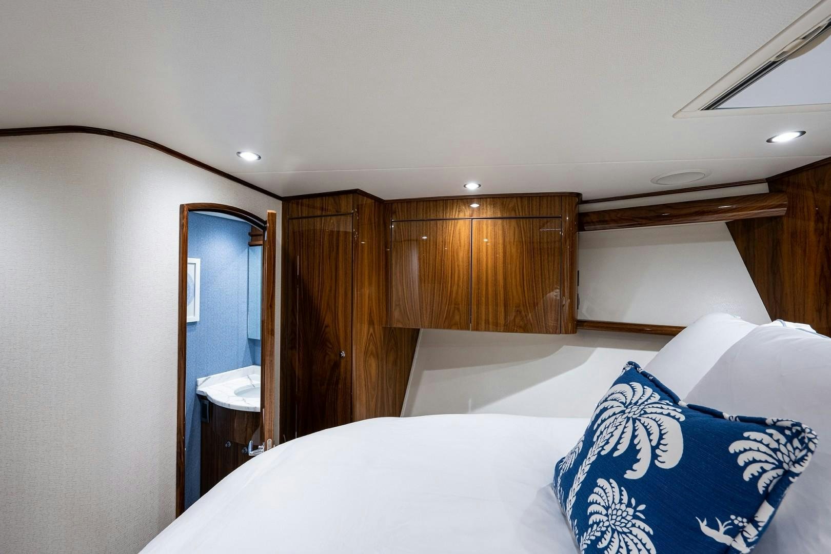 a bedroom with a bed and a mirror aboard REEL CRAZY Yacht for Sale