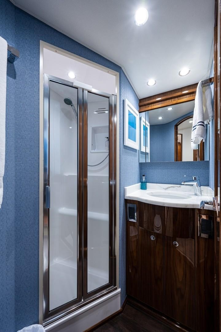 a bathroom with a glass shower aboard REEL CRAZY Yacht for Sale