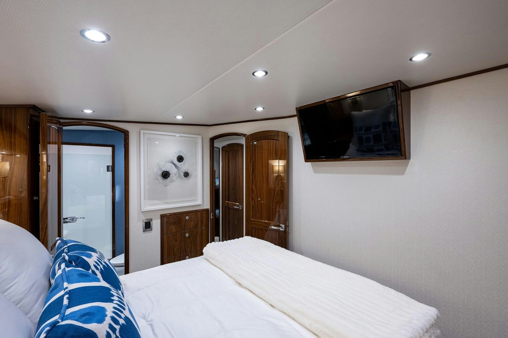 a hotel room with a bed and television aboard REEL CRAZY Yacht for Sale
