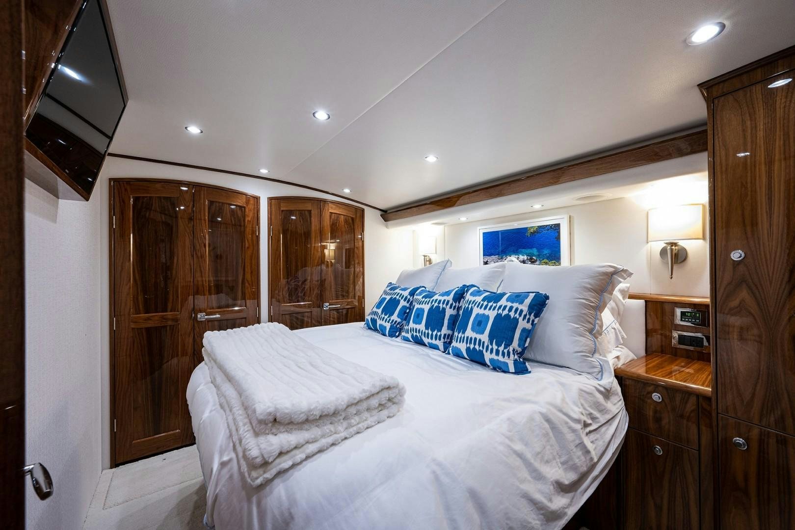 a bedroom with a bed and a closet aboard REEL CRAZY Yacht for Sale