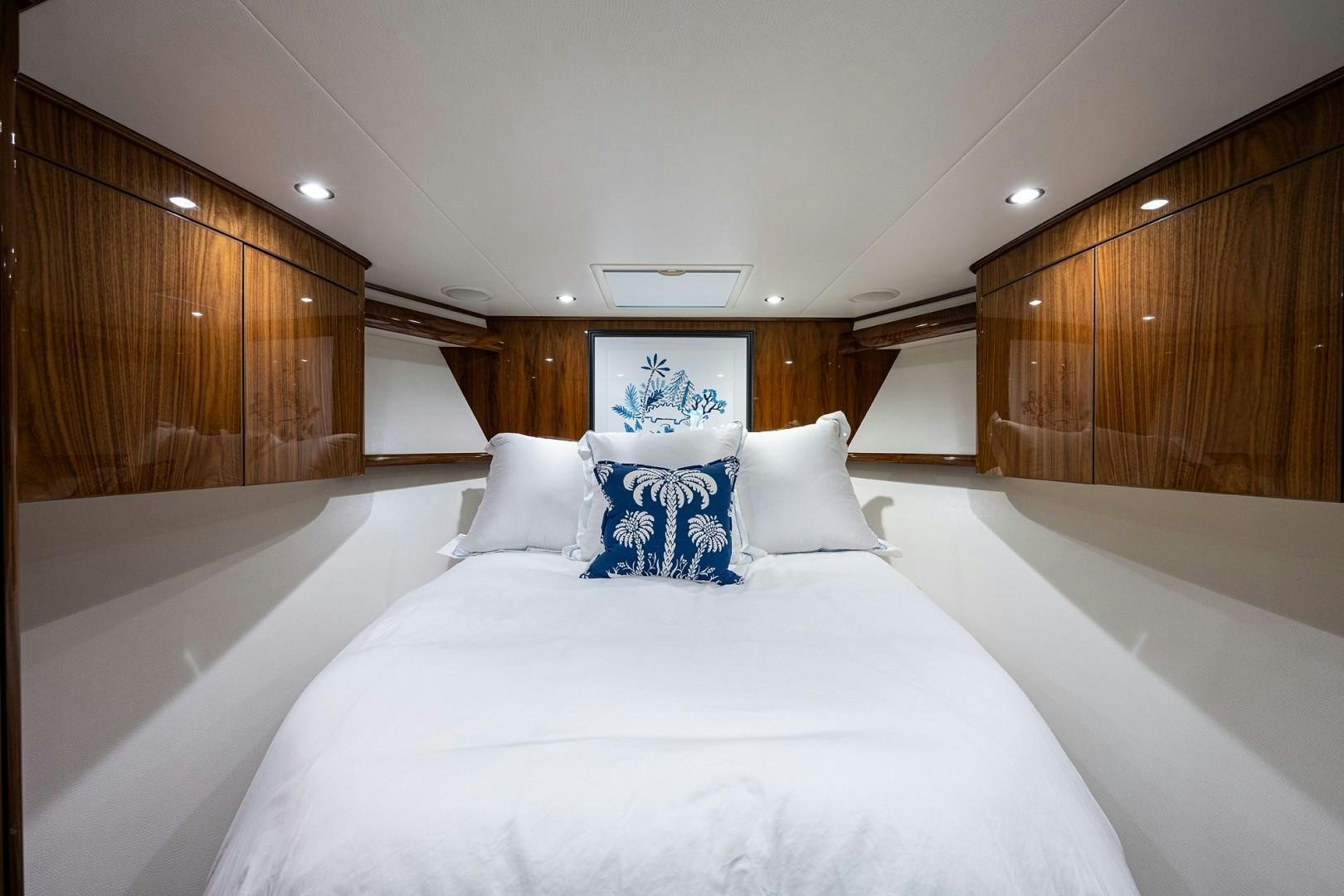 a bed with white sheets and pillows aboard REEL CRAZY Yacht for Sale