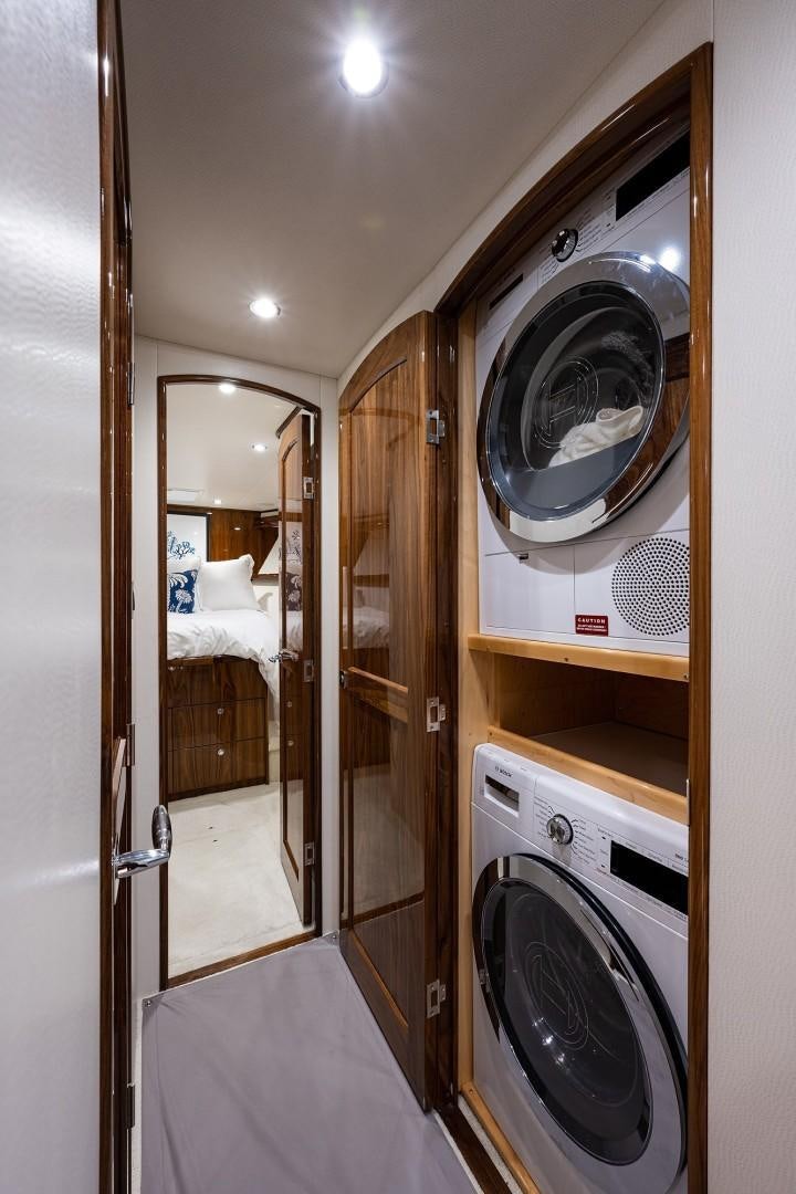a bathroom with a washer and dryer aboard REEL CRAZY Yacht for Sale