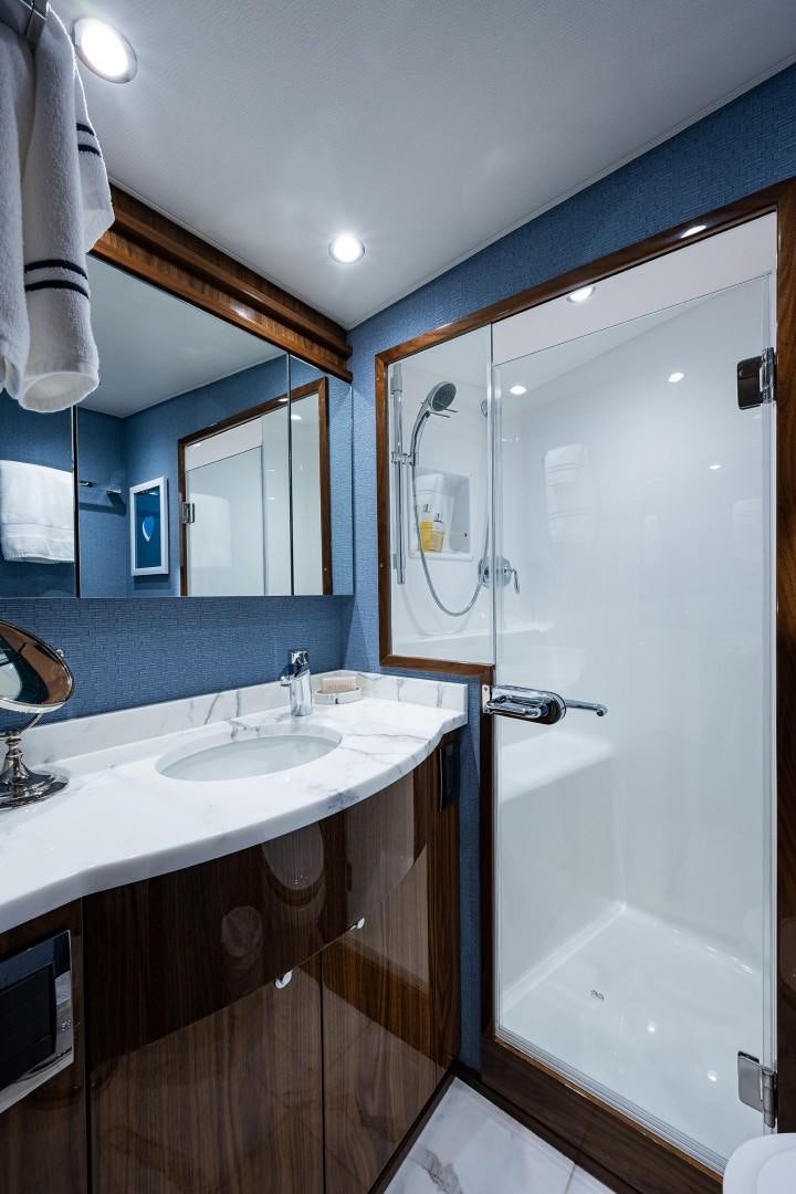 a bathroom with a sink and a mirror aboard REEL CRAZY Yacht for Sale