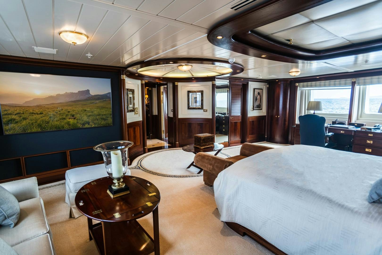 a hotel room with a bed and a coffee table aboard FARIBANA V Yacht for Sale