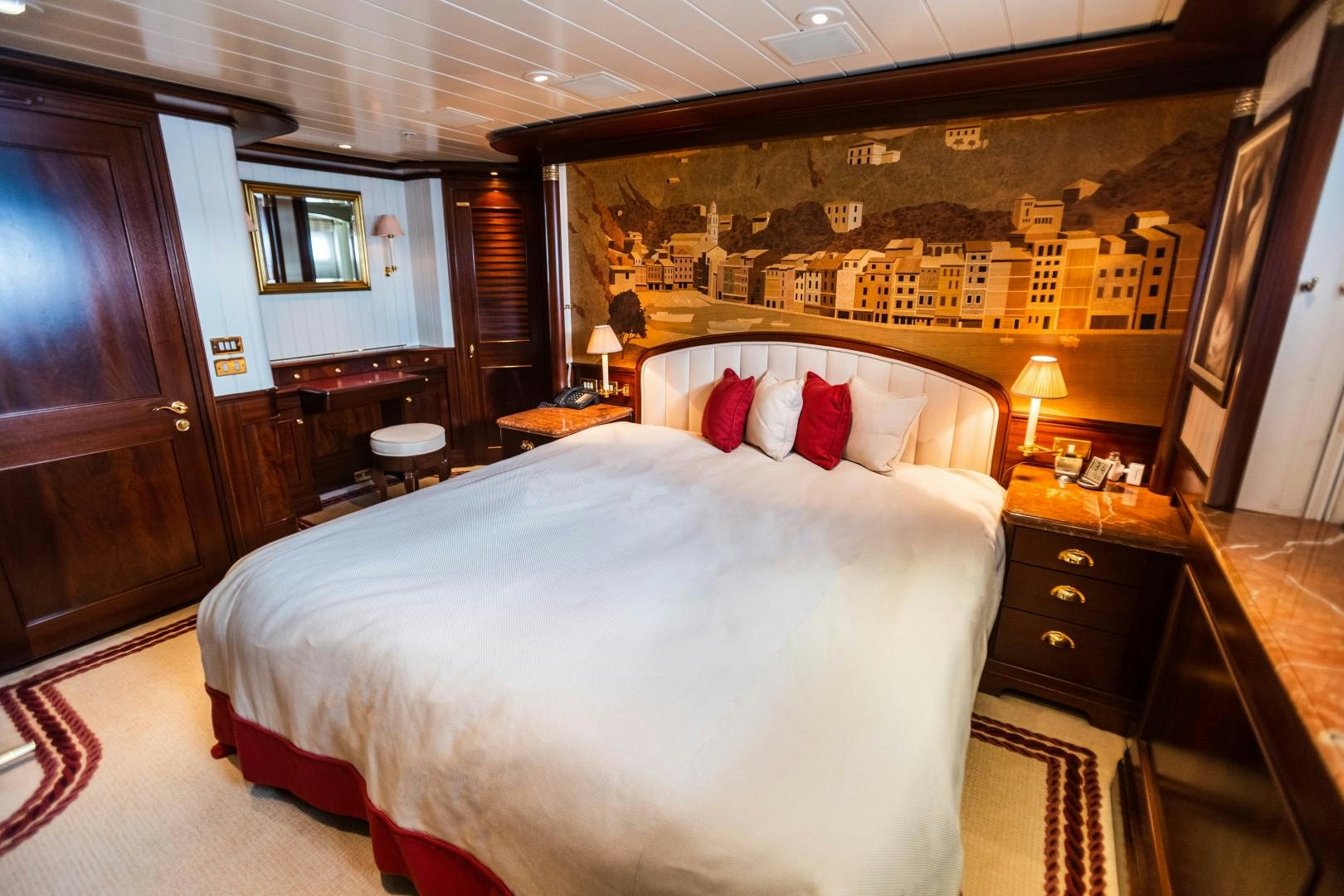 a bedroom with a large bed aboard FARIBANA V Yacht for Sale