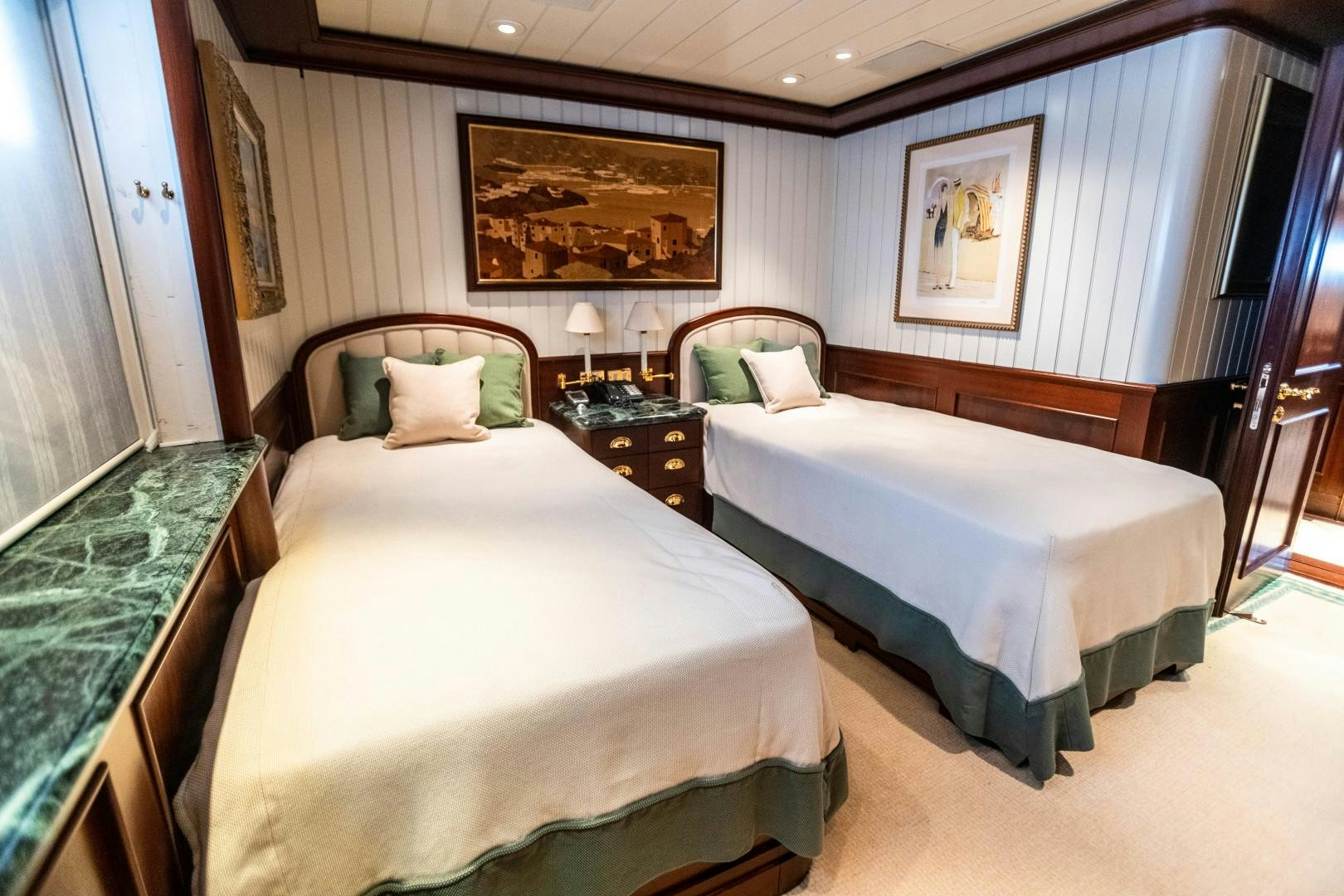 a couple of beds in a hotel room aboard FARIBANA V Yacht for Sale