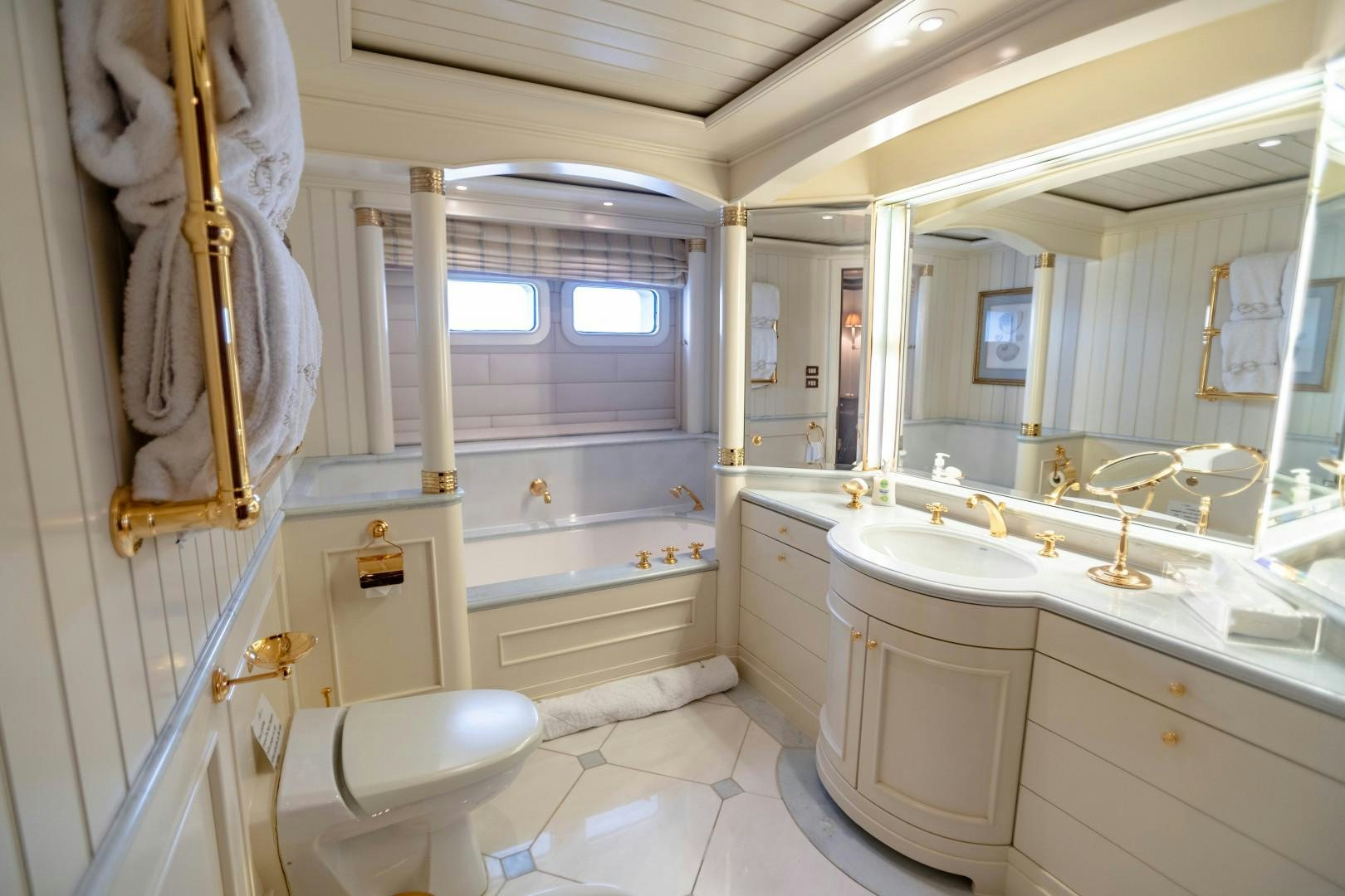 a bathroom with a tub sink and toilet aboard FARIBANA V Yacht for Sale
