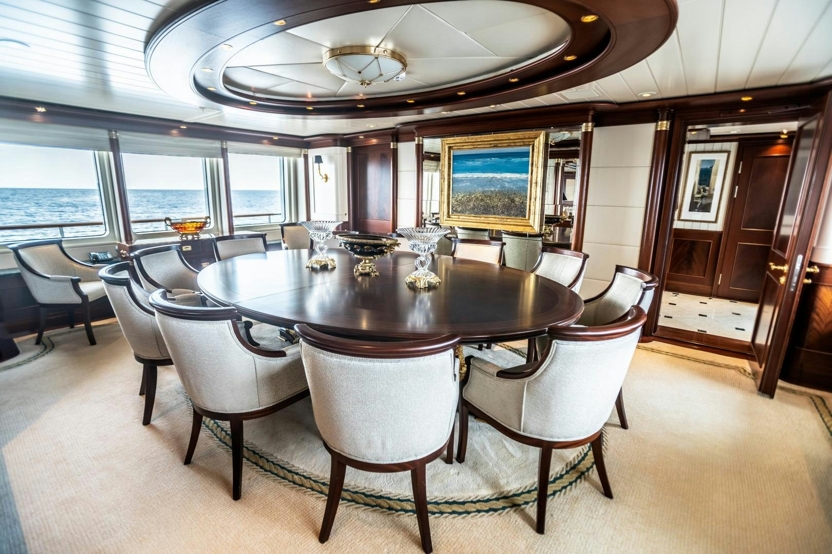 a large dining table in a room aboard FARIBANA V Yacht for Sale