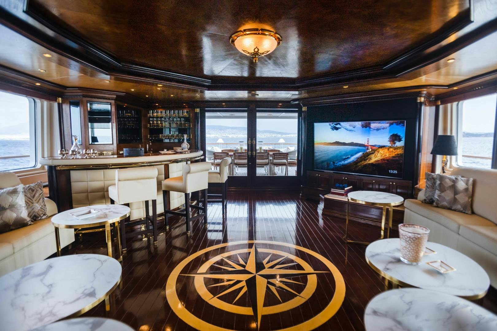a living room with a large television aboard FARIBANA V Yacht for Sale