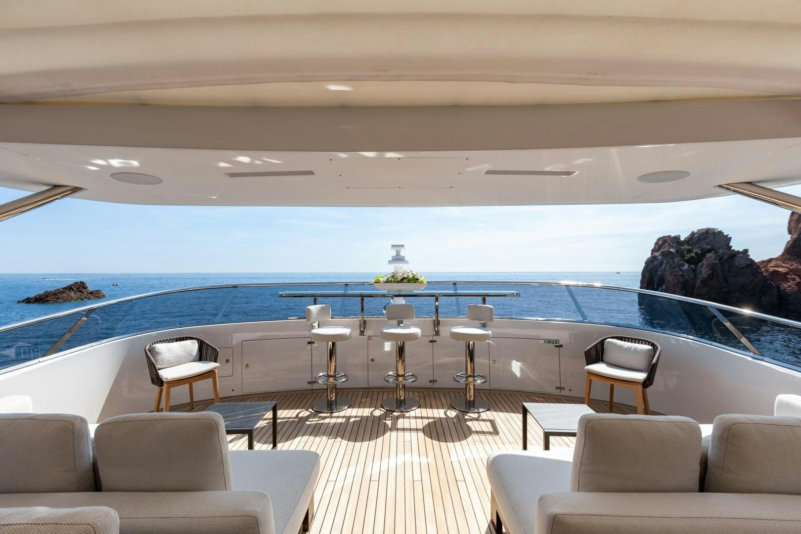 a swimming pool with chairs and a table and chairs aboard JACOZAMI Yacht for Sale