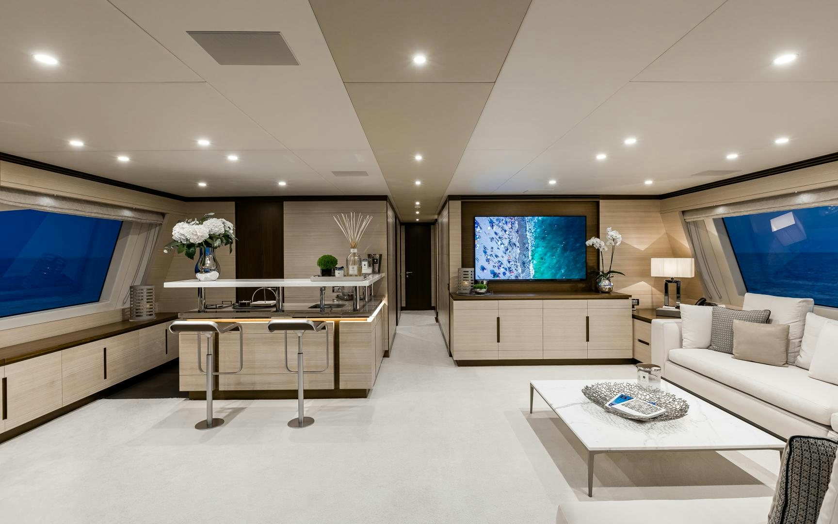 a living room with a large screen aboard JACOZAMI Yacht for Sale