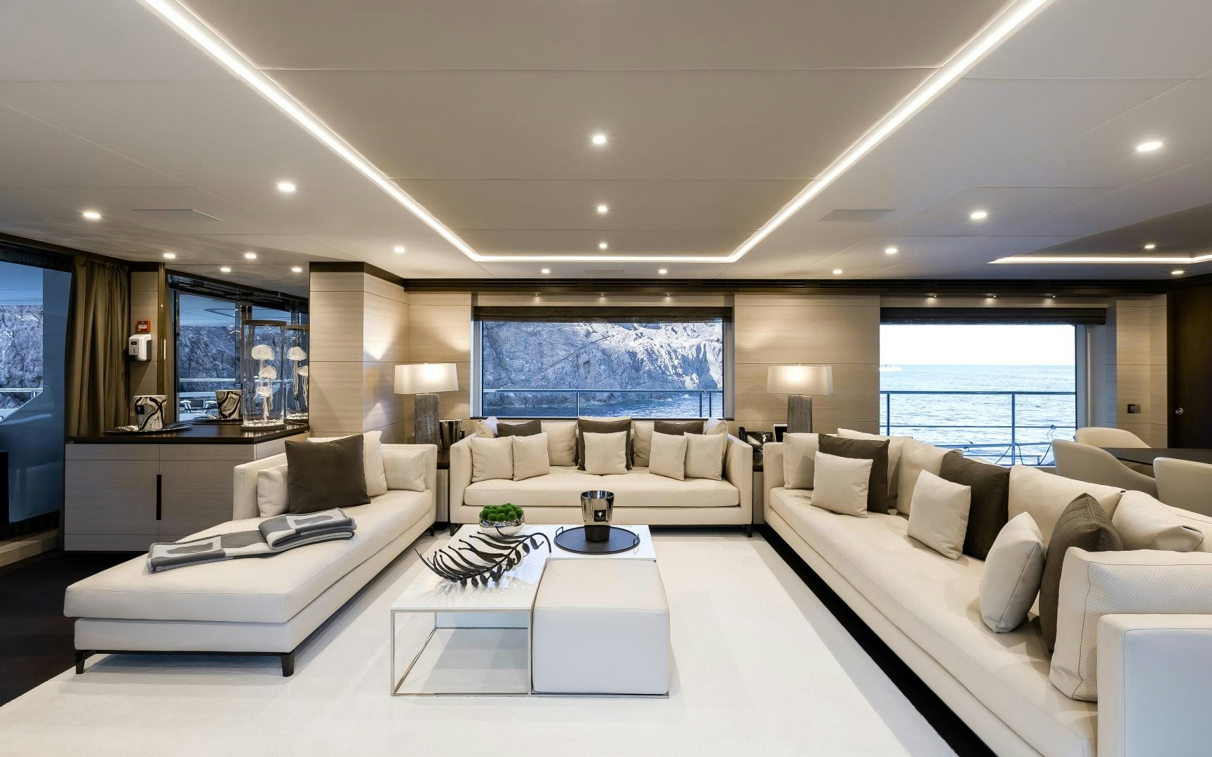 a large living room with white furniture aboard JACOZAMI Yacht for Sale
