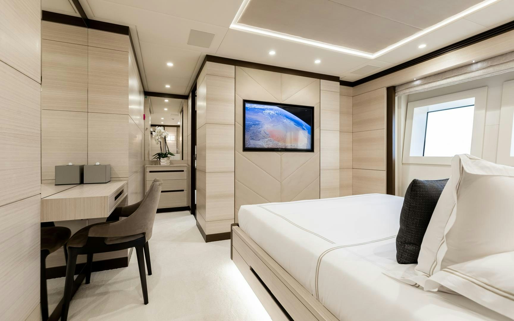a room with a bed and a tv on the wall aboard JACOZAMI Yacht for Sale