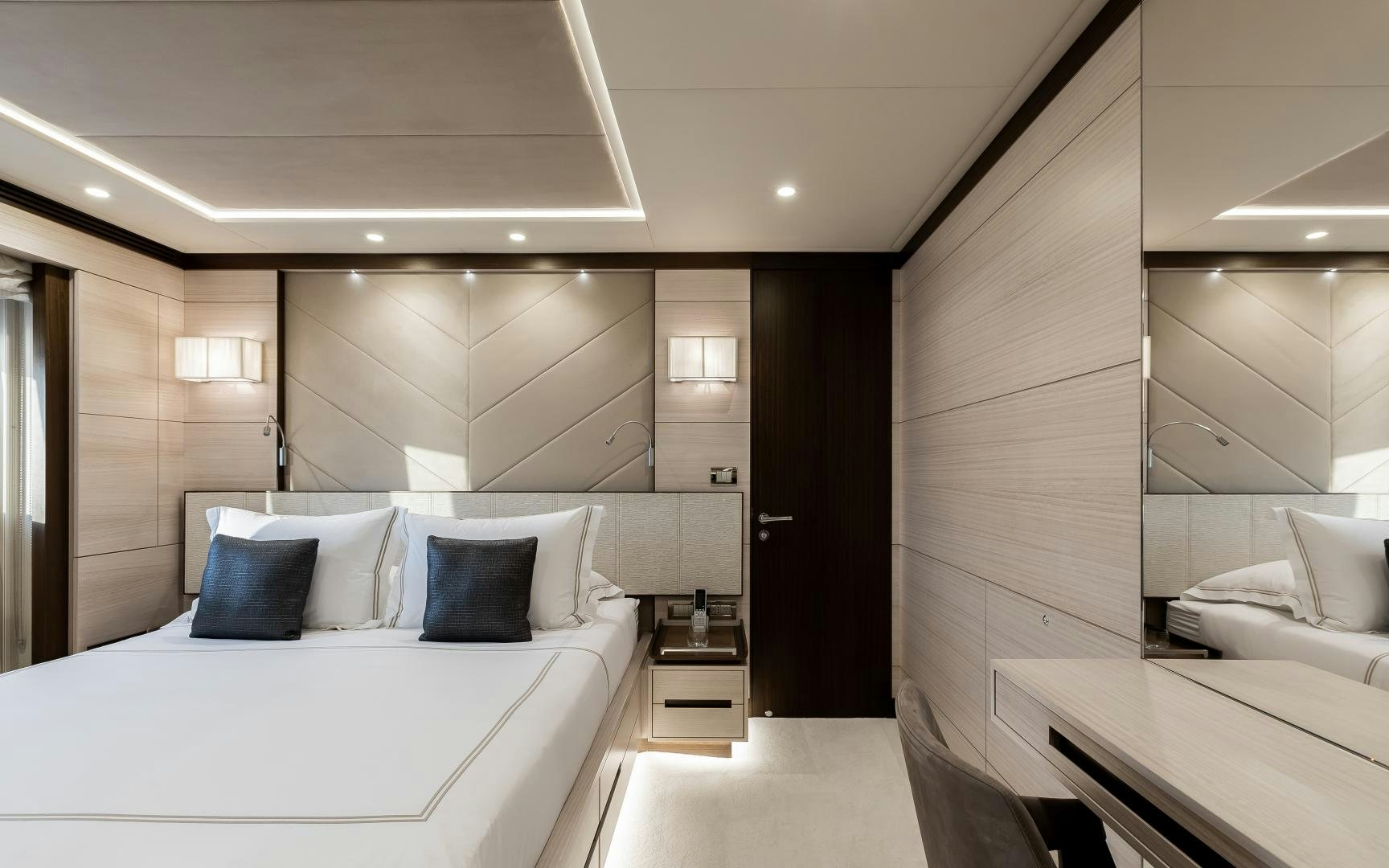 a room with a bed and a desk aboard JACOZAMI Yacht for Sale