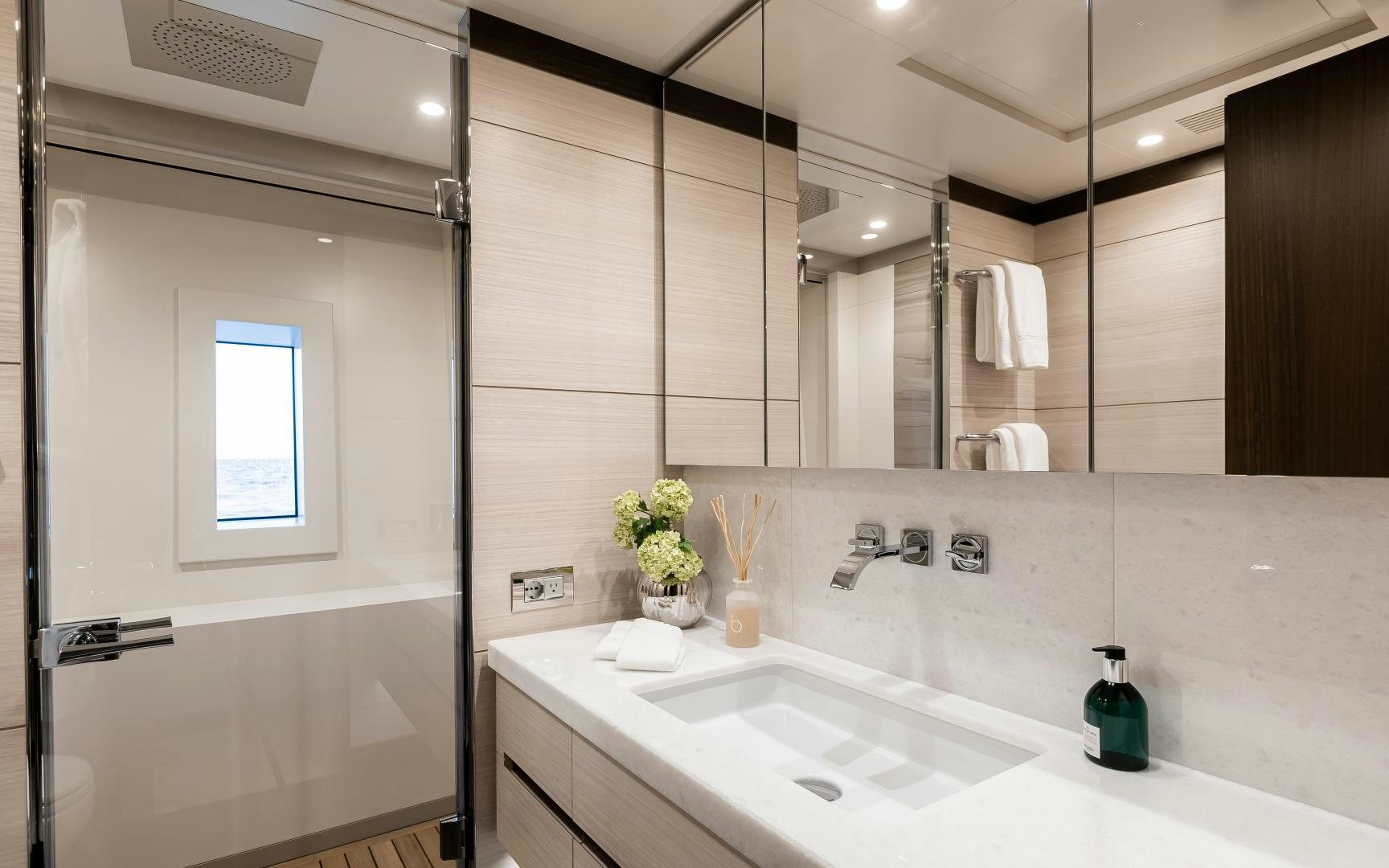 a bathroom with a large mirror aboard JACOZAMI Yacht for Sale