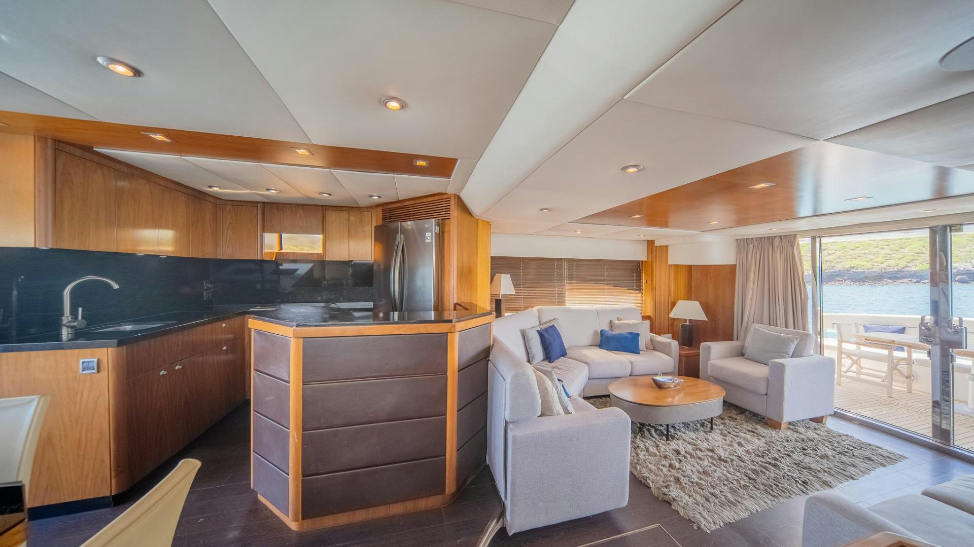 a living room with a kitchen and dining area aboard GOOD LACK Yacht for Sale