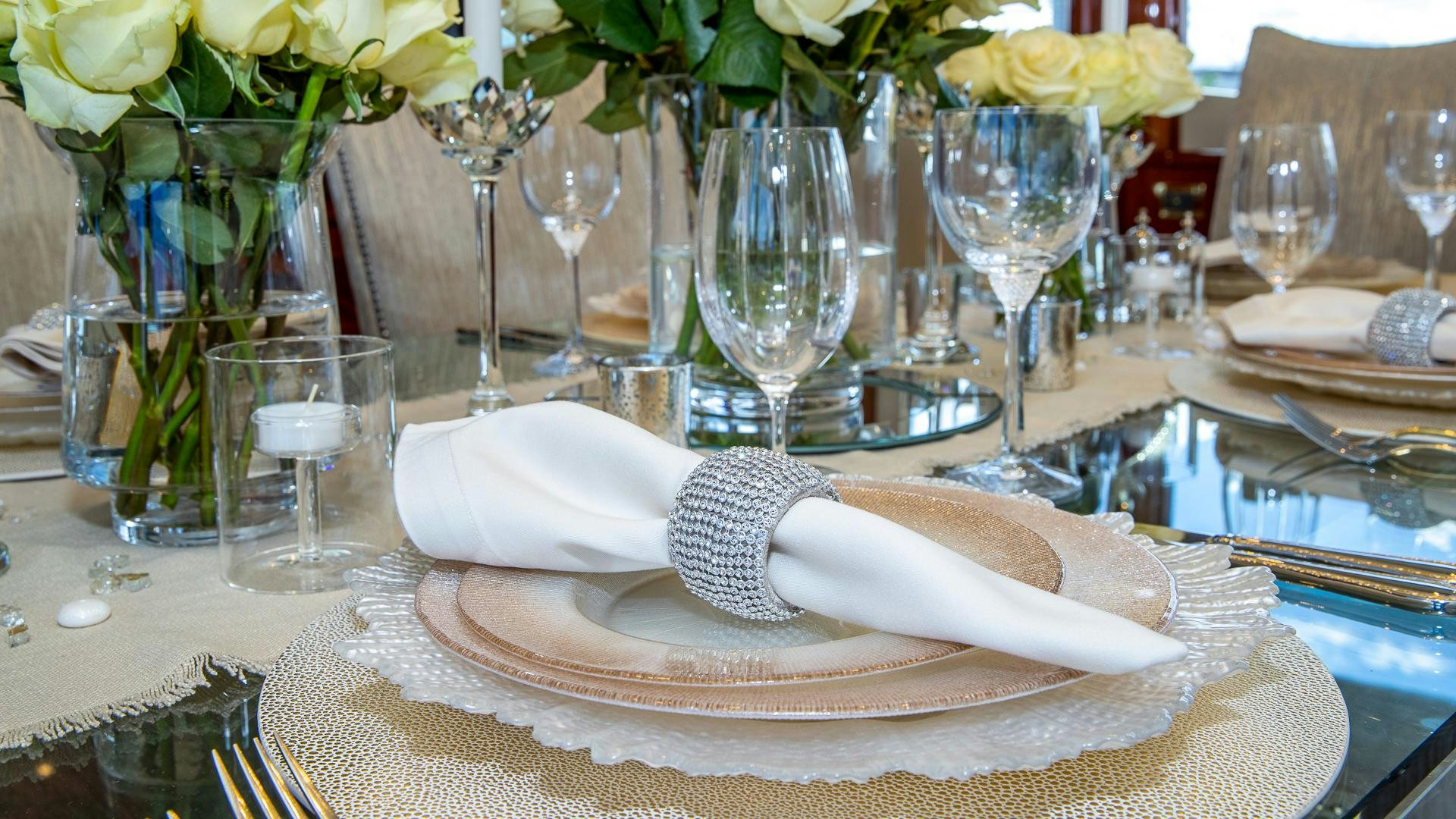 a white hat on a plate with glasses and a napkin aboard HOPE FLOATS Yacht for Sale