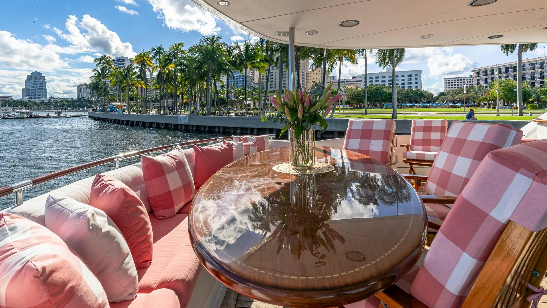 a table with chairs on it next to a body of water aboard HOPE FLOATS Yacht for Sale
